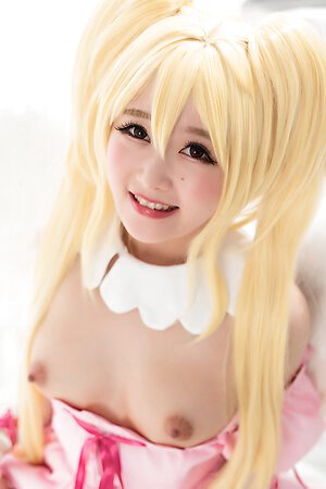 Japanese blonde doll Ria Kurumi with pink dress shows her shaved pussy close up
